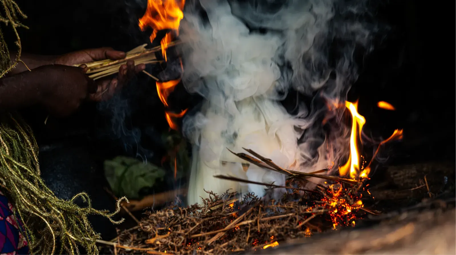 A Batwa guide demonstrating traditional fire-making on the Batwa trail